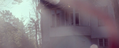 a blurry photo of a house in the woods