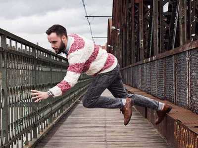 a man jumping in the air on a bridge