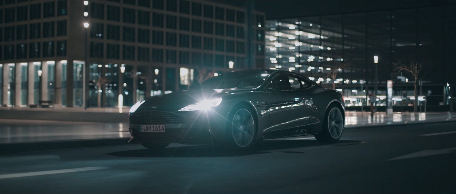 a car driving down a city street at night