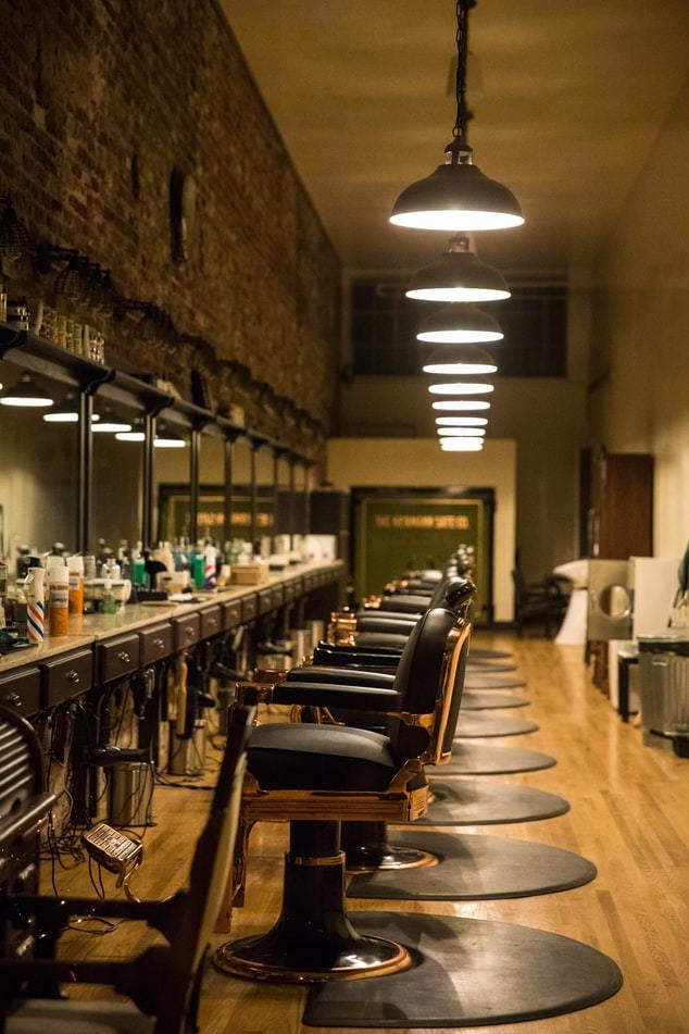 a row of chairs sitting in front of a bar