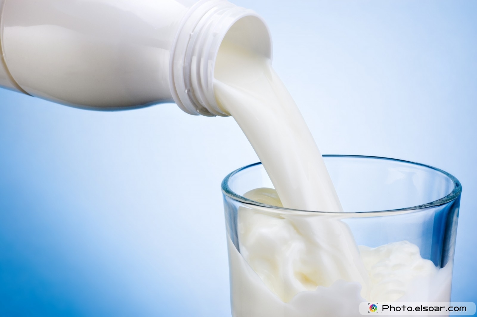 a glass of milk being poured into it