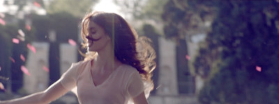 a woman walking down a street with a frisbee in her hand