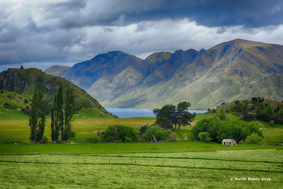 a green field with mountains in the background