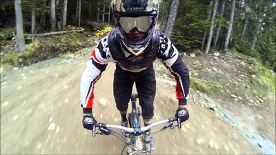 a man riding a bike down a dirt road