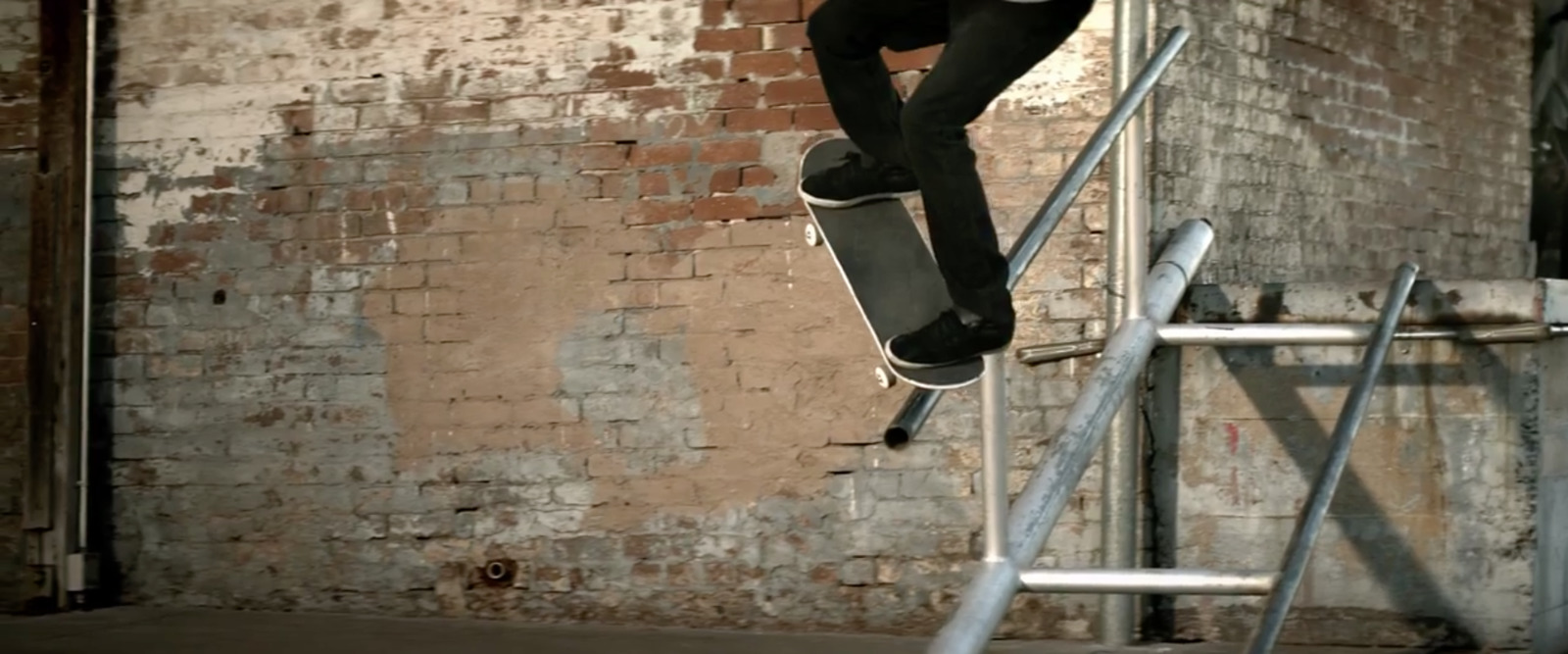 a man riding a skateboard up the side of a metal rail