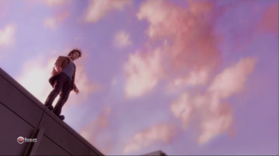 a man standing on the edge of a building