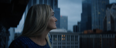 a woman standing in front of a city skyline