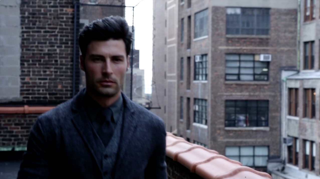 a man standing on top of a roof next to tall buildings