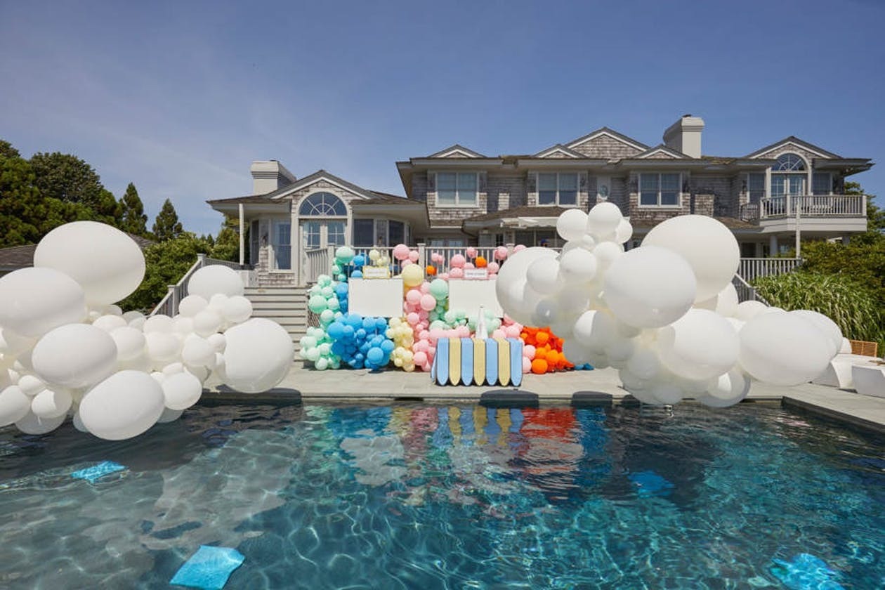 a pool with a bunch of balloons floating in it