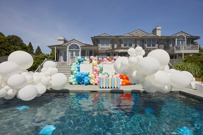 a pool with a bunch of balloons floating in it