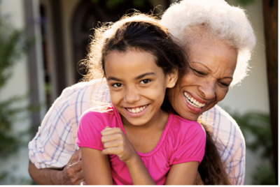 an older woman hugging a young girl