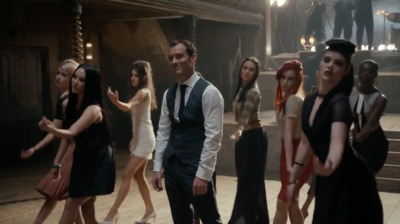 a man standing in front of a group of women