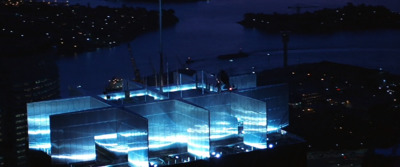 an aerial view of a building lit up at night