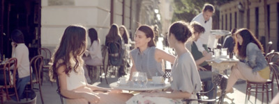 a group of people sitting around a table eating food