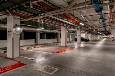 an empty parking garage with red and white lines