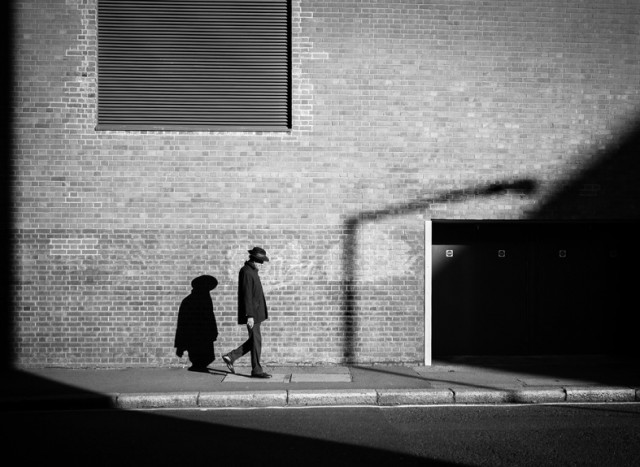 a man and a woman walking down a sidewalk