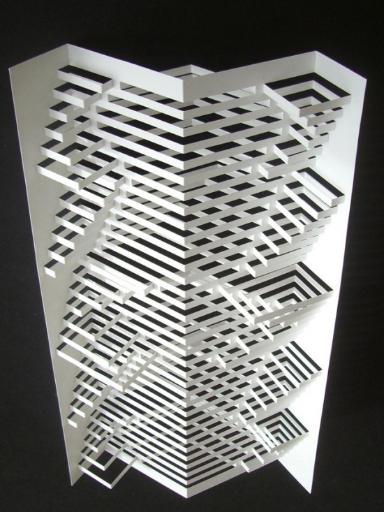 a sculpture made out of white paper on a black surface