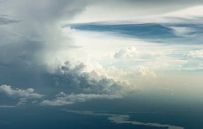 an airplane flying in the sky with a lot of clouds