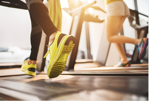 a couple of people running on a treadmill