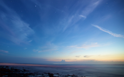 a blue sky with some clouds and some stars