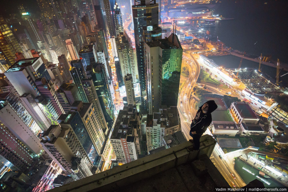 a man standing on top of a tall building