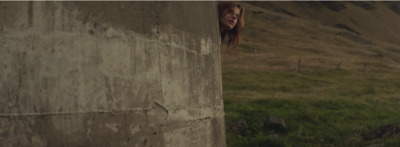 a woman sticking her head out of a wall