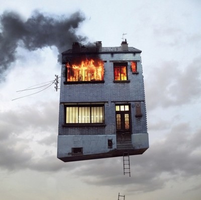 a house on fire with smoke coming out of the windows