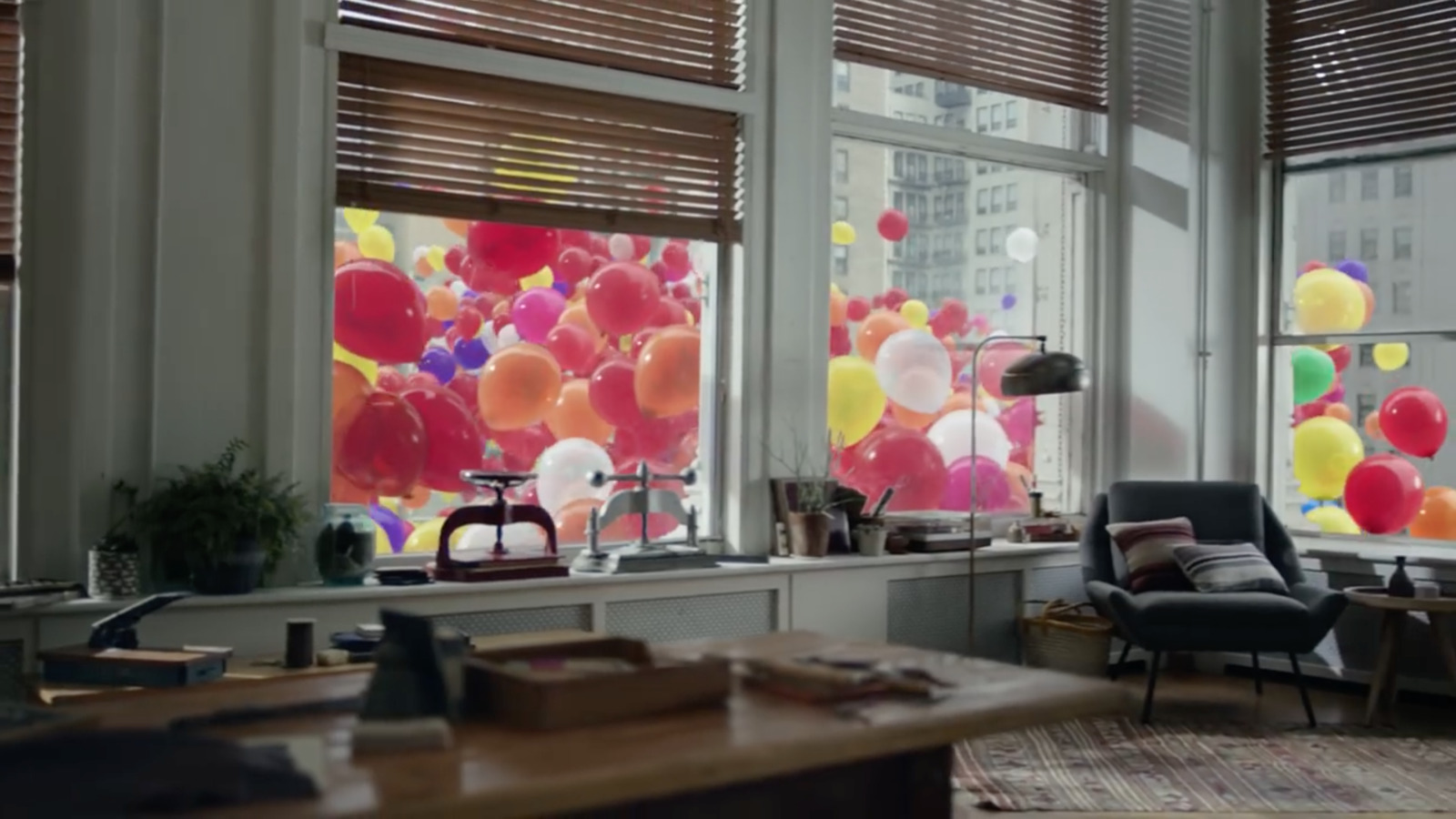 a living room filled with lots of windows covered in balloons