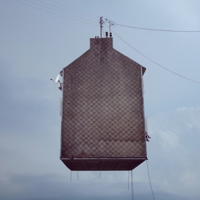 a tall building with a weather vane on top of it