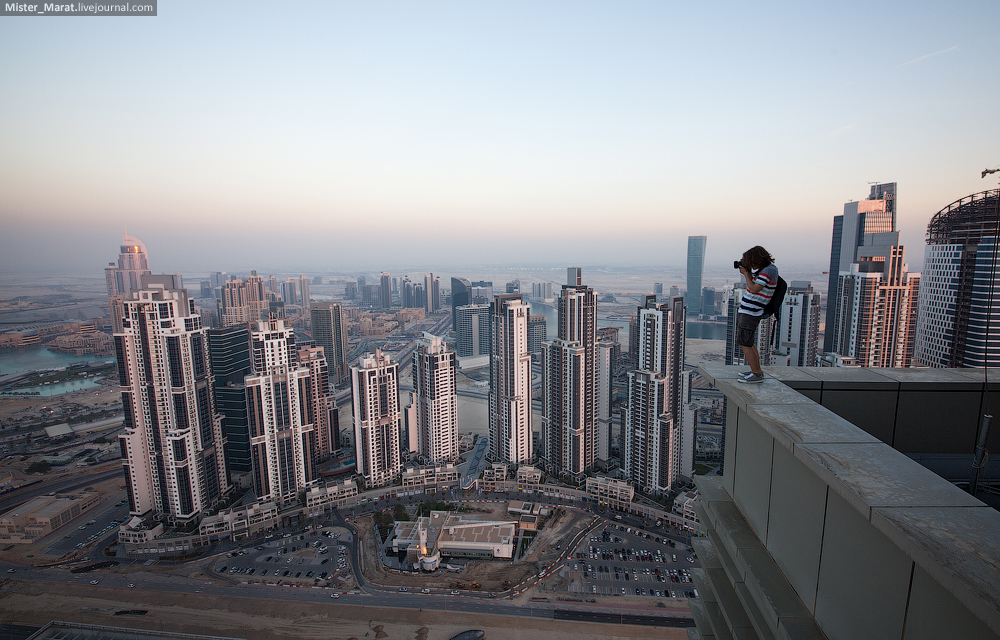 a man standing on top of a tall building