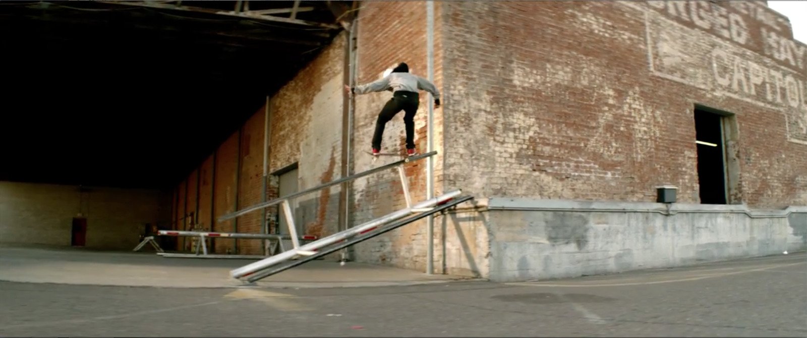 a man riding a skateboard down the side of a metal rail