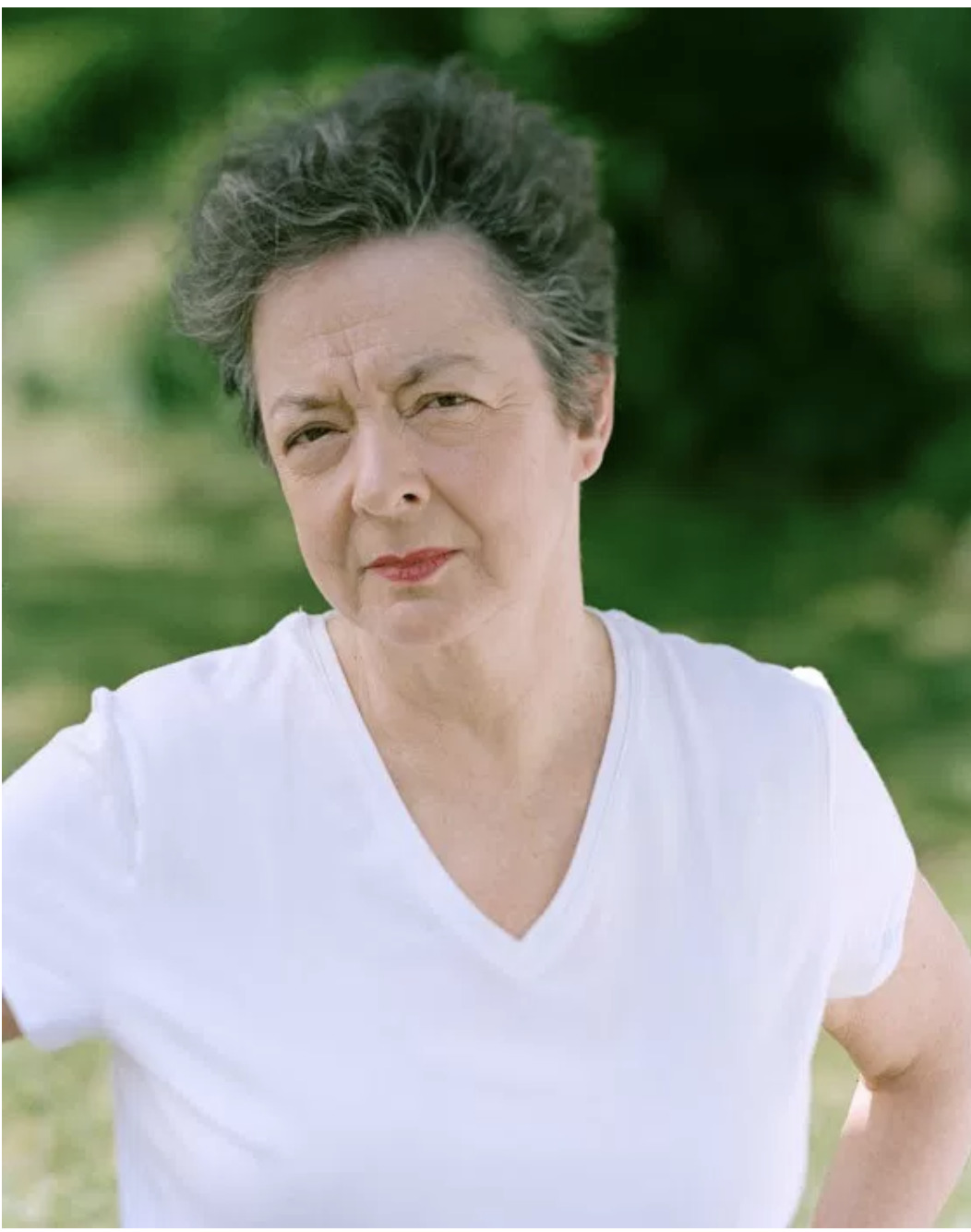 a woman in a white shirt posing for a picture