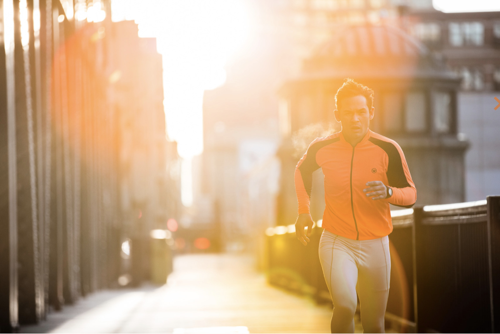 a man running down a city street at sunset