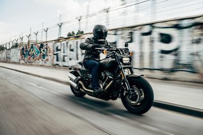 a man riding a motorcycle down a street