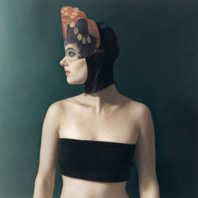 a woman in a black bikini top with a hat on her head