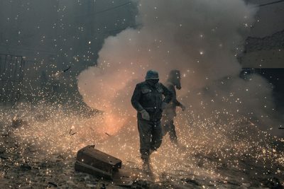 a man walking through a smoke filled street