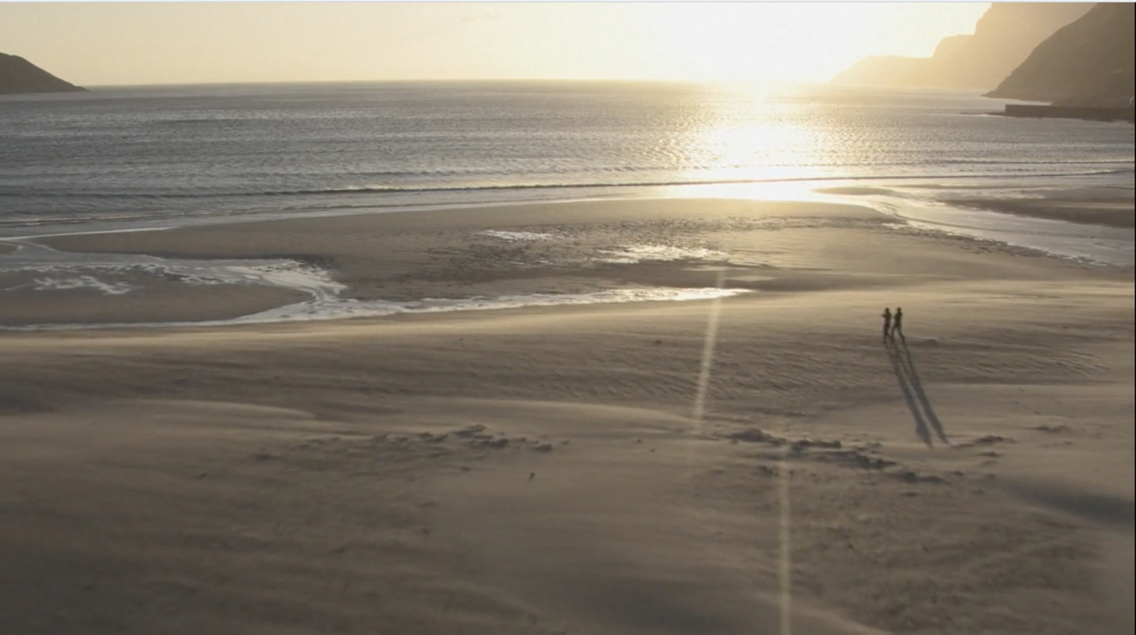 an aerial view of a beach at sunset