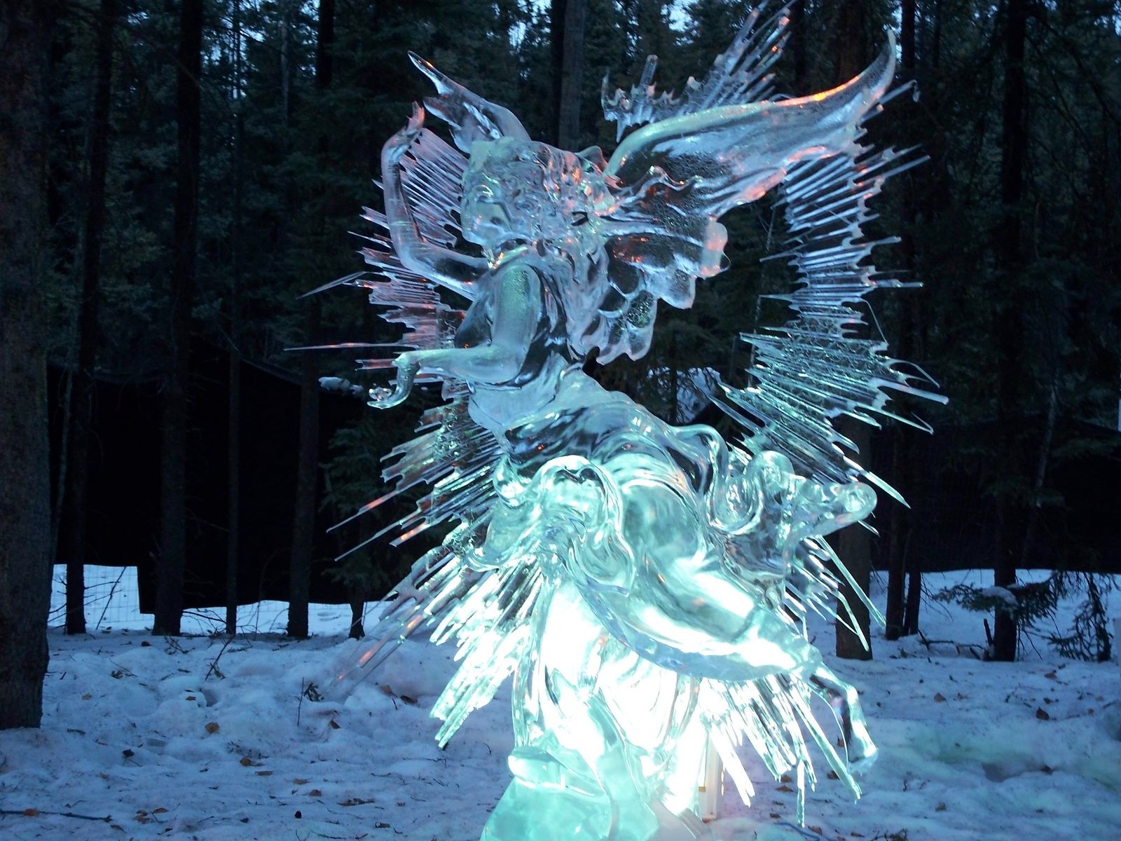 an ice sculpture of an angel in the snow