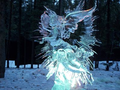 an ice sculpture of an angel in the snow