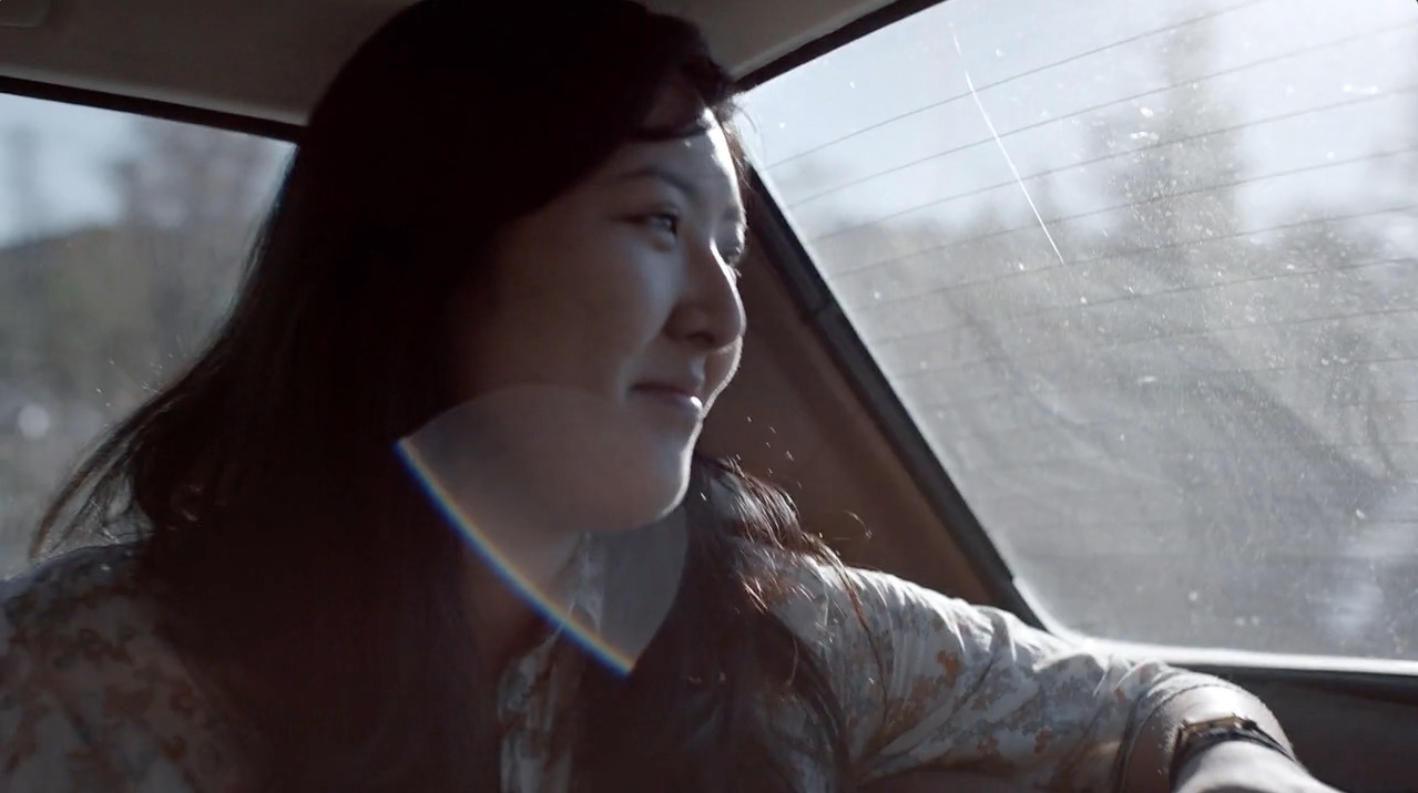 a woman driving a car in the rain