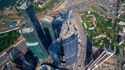 an aerial view of two skyscrapers in a city