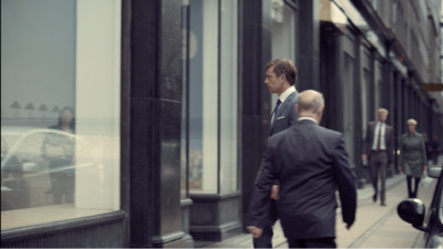 a man in a suit walking down the street