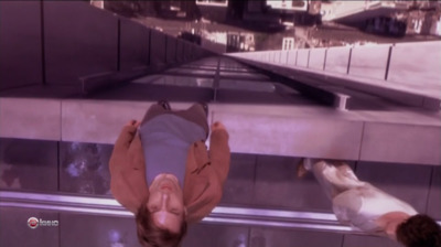 a man is upside down on a glass floor