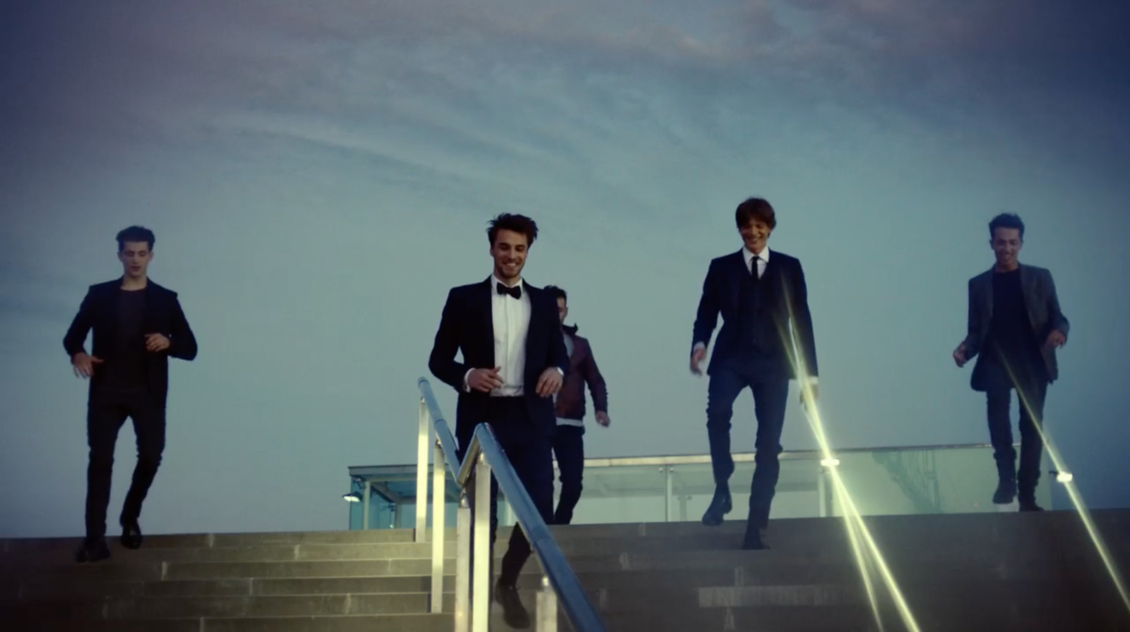 a group of men walking down a flight of stairs