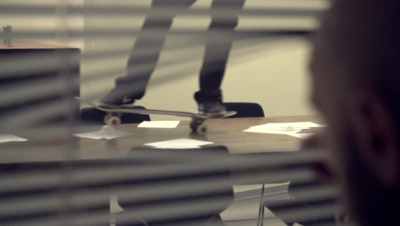 a man riding a skateboard on top of a wooden table