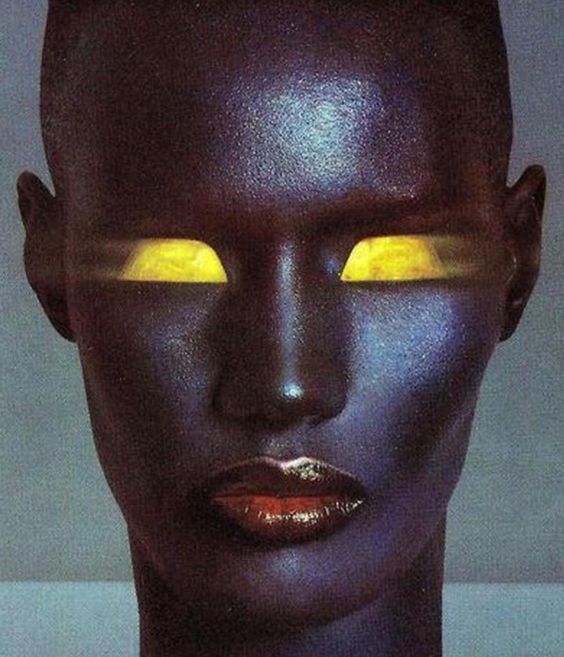 a woman's face with yellow eyes