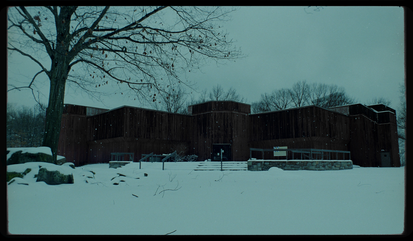 a building in the middle of a snowy field