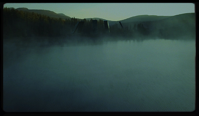 a body of water surrounded by mountains and trees