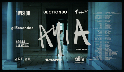 a person standing in a hallway with the words axia written on it