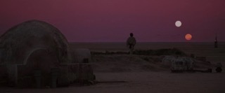 a person walking in the desert at sunset